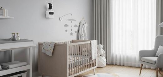 Modern nursery with pan-tilt-zoom baby monitor camera mounted on wall overlooking crib