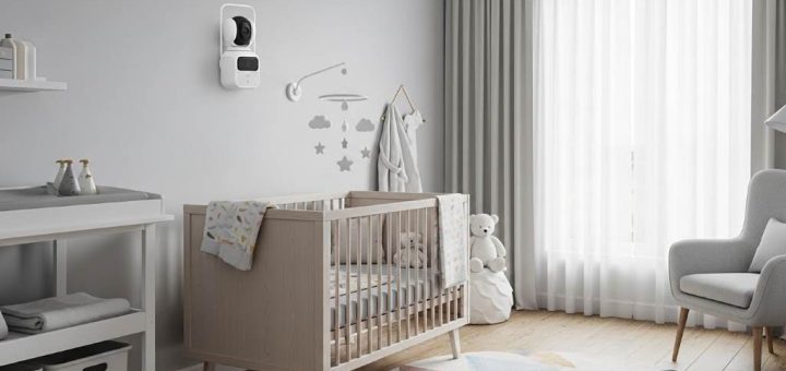 Modern nursery with pan-tilt-zoom baby monitor camera mounted on wall overlooking crib